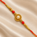Eshanarya Traditional Pearl Designer Rakhi with Gold-Tone Circular Centrepiece, Red Beads and Red-Yellow Thread for Raksha Bandhan