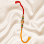 Vertical display of Eshanarya Ganesha Peacock Feather Rakhi on cream satin fabric
