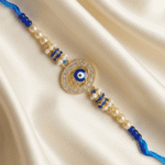 Premium Blue Hamsa Designer Rakhi with Evil Eye motif, crystal border and decorative pearl detailing for Raksha Bandhan.