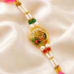 Close-up of premium Shree Rakhi featuring crystal work, pearls and colorful enamel design