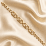 Minimalist gold finish Bracelet Rakhi by Eshanarya with geometric centre design on luxurious satin fabric.