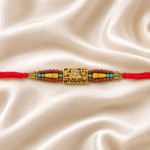 Close-up of Mahakal Rakhi featuring gold-tone Mahakal motif, crystal stones and Rudraksha-inspired beadwork