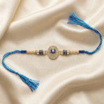 Blue Hamsa Evil Eye Rakhi for Brother displayed with an oval crystal centrepiece and soft braided blue thread.