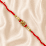 Luxury Royal Floral Crystal Rakhi displayed on satin cloth