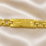 Close-up of Eshanarya engraved Bracelet Rakhi highlighting the textured rectangular centre design with gold finish