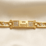 Close-up of the Jai Mata Di engraved Bracelet Rakhi highlighting crystal embellishments and devotional centrepiece.