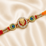 Detailed view of Ganesha Designer Rakhi featuring crystal stones and peacock feather accents