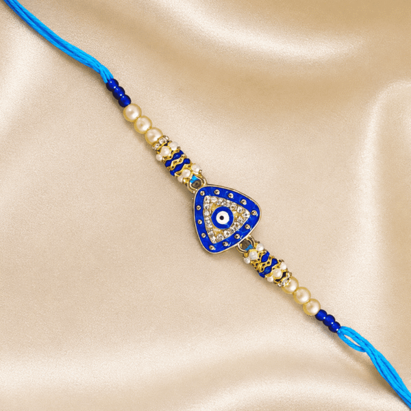 Designer Blue Nazar Rakhi with a triangular evil eye centrepiece, sparkling crystals and pearl accents for brothers.