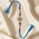 Minimalist Blue Hamsa Evil Eye Designer Rakhi featuring pearl beads, crystal stones and an oval Nazar charm.