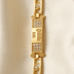 Vertical view of Eshanarya Gold Finish Jai Mata Di Bracelet Rakhi with crystal-studded centre design for Raksha Bandhan.
