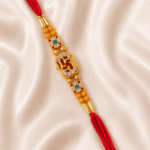 Diagonal close-up of Eshanarya premium Swastik designer rakhi on satin fabric