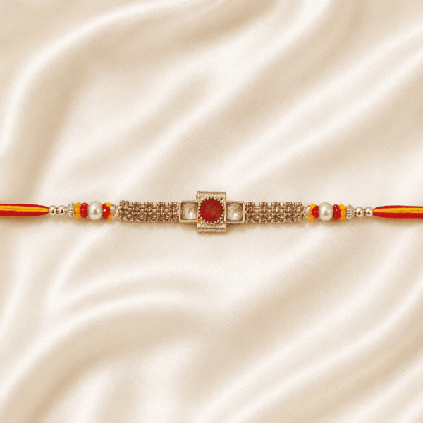 Horizontal view of Eshanarya Regal Ruby Bracelet Rakhi on luxury satin fabric