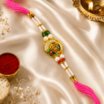 Festive designer Shree Rakhi with kumkum, rice and diya on satin background for Raksha Bandhan