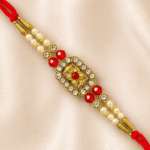 Close-up of handcrafted floral crystal designer rakhi with ruby-red beads and pearl accents