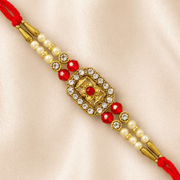 Close-up of handcrafted floral crystal designer rakhi with ruby-red beads and pearl accents