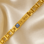 Premium Gold-Tone Bracelet Rakhi with Blue Crystal and Hindi Engraving by Eshanarya