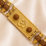 Macro shot of Om symbol bracelet rakhi featuring rudraksha beads and textured gold-tone centrepiece