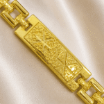 Macro image of Eshanarya gold Bracelet Rakhi featuring an engraved geometric centre plate for Raksha Bandhan gifting