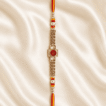 Vertical close-up of premium red crystal designer rakhi with pearl bead detailing