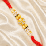 Luxury Crystal Pearl Designer Rakhi for Brother displayed on satin fabric with festive styling