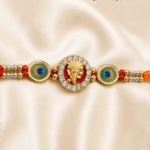 Symmetrical close-up of Eshanarya Lord Ganesha Designer Rakhi with peacock feather design