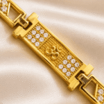 Detailed angled view of Eshanarya Om Bracelet Rakhi showcasing crystal detailing and minimalist gold bracelet design