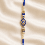 Crystal Blue Nazar Designer Rakhi highlighting the evil eye centrepiece with pearl detailing and premium craftsmanship.