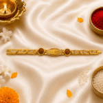 Eshanarya Mere Bhai Bracelet Rakhi displayed with diya, kumkum, rice, jasmine flowers and marigold petals for Raksha Bandhan celebration