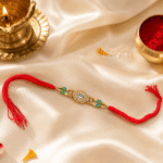 Premium designer Rakhi displayed with diya, kumkum, rice, and festive Raksha Bandhan decorations