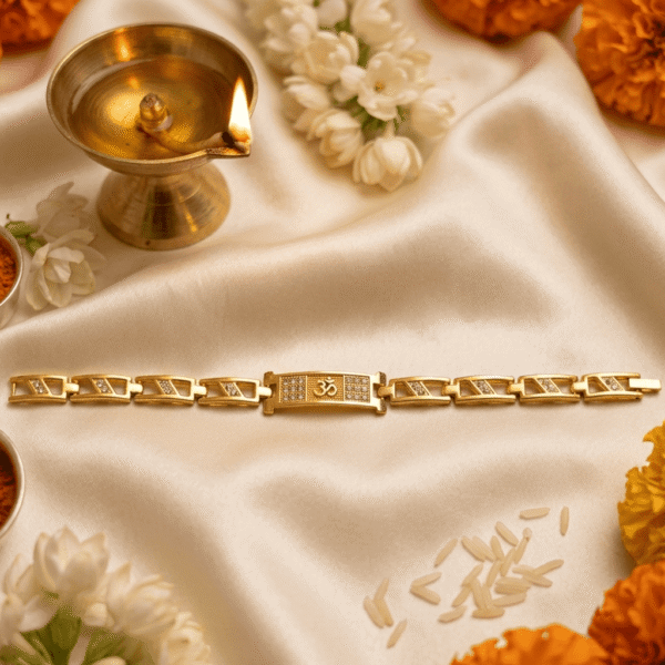 Festive lifestyle image of Eshanarya Om Bracelet Rakhi with diya, kumkum, rice and floral decorations on satin fabric