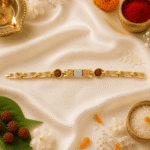 Festive flat lay of Eshanarya Om Rudraksha Bracelet Rakhi with diya, kumkum, rice, flowers and traditional Raksha Bandhan pooja elements.