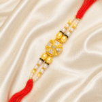 Premium designer Rakhi with crystal embellishments, pearl beads and sacred red thread for Raksha Bandhan gifting