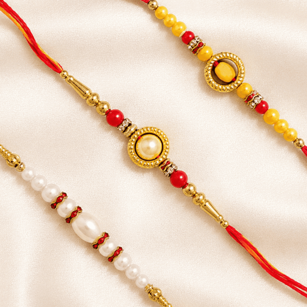 Close-up of Eshanarya Rakhi Collection featuring Pearl Designer Rakhi, Gold Oval Designer Rakhi and Traditional Red Thread Rakhi